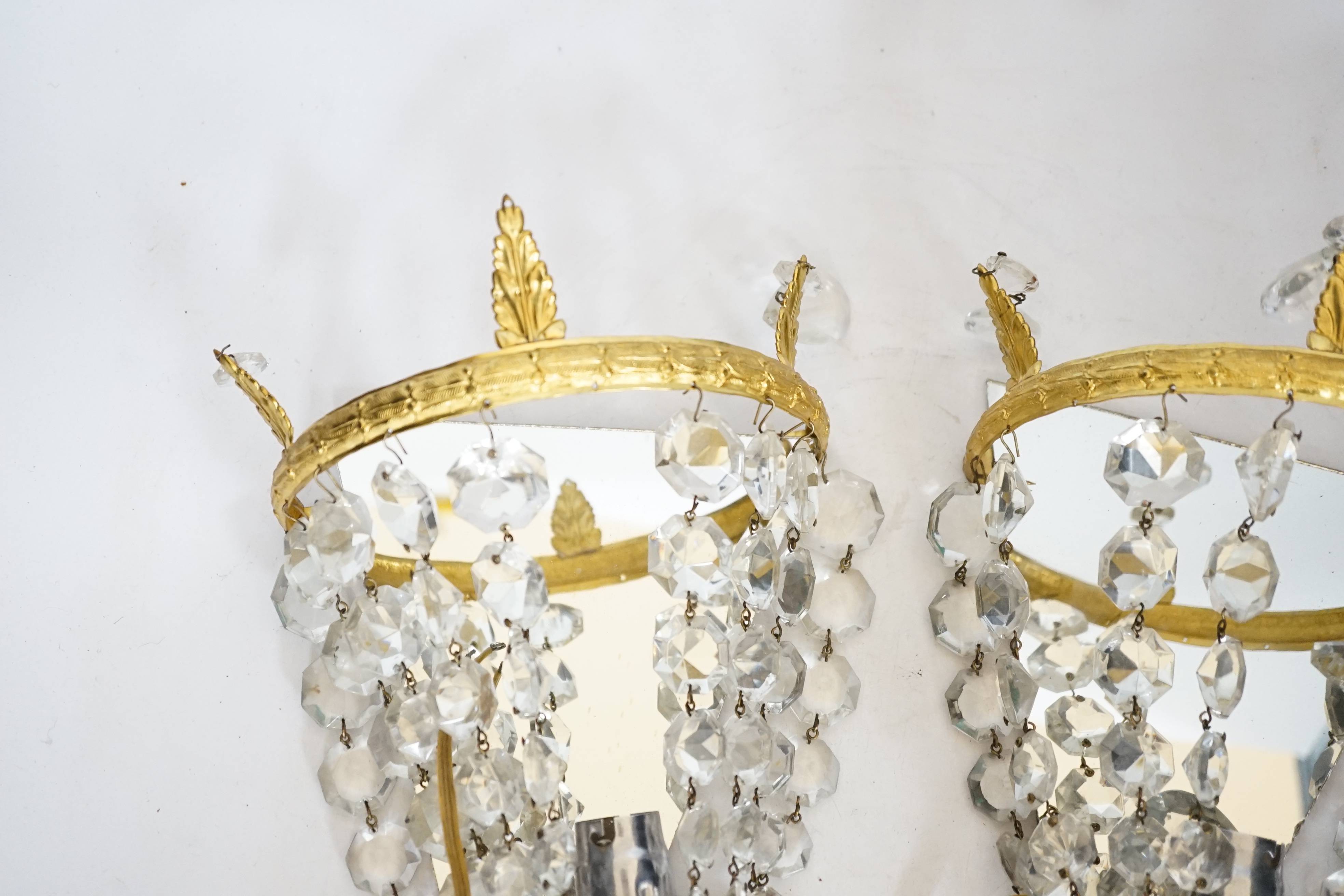A pair of gilt mounted lustre wall lights, 23cm high